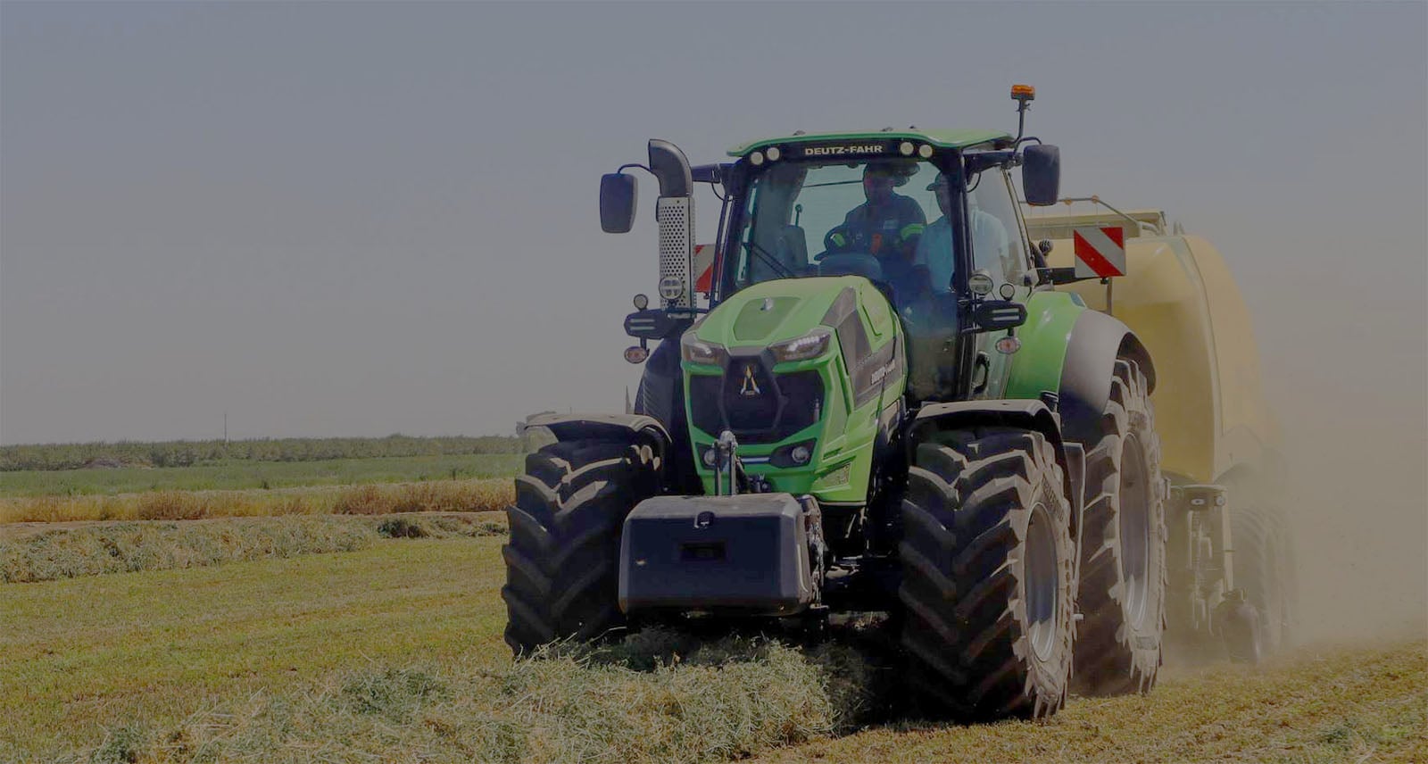 Tractor pulling a Vermeer Baler